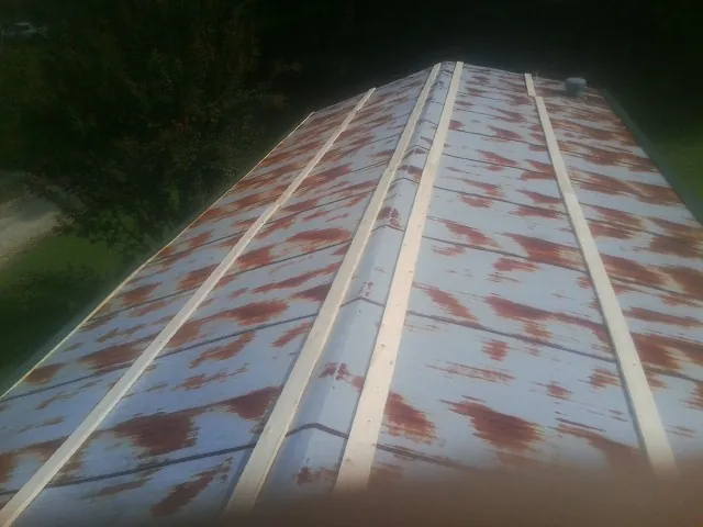 Rusted metal roof panels with new wood purlins before replacement — Storm Damage Roof Repair in Seneca by Roofing Brothers